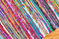Close up on hand woven colorful rug at angle